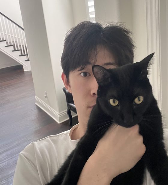 Will holding his black cat